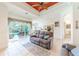 Spacious living room with comfortable seating and access to the pool area at 125 Amora Ave, Venice, FL 34285