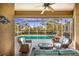 Relaxing patio with wicker furniture overlooking a refreshing pool at 125 Amora Ave, Venice, FL 34285