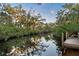 Serene canal view with wooden dock at 1255 Paradise Way, Venice, FL 34285