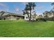 Single-story home with covered patio and manicured lawn at 1255 Paradise Way, Venice, FL 34285