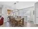 Bright dining room with wooden table and access to a balcony at 128 Navigation Cir # 103, Osprey, FL 34229