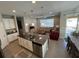 Open kitchen and living room with an island and modern appliances at 128 Navigation Cir # 103, Osprey, FL 34229