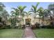 Community pool area with palm trees and brick pathway at 128 Navigation Cir # 103, Osprey, FL 34229