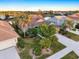 Beautiful aerial view of a landscaped home with tile roof and waterfront access at 1307 Highland Greens Dr, Venice, FL 34285