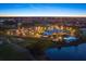 Aerial night view of the community clubhouse, pool, and golf course, showcasing the community's upscale amenities at 1307 Highland Greens Dr, Venice, FL 34285
