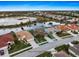 Aerial shot highlighting the property line and surrounding community with a scenic pond view at 1307 Highland Greens Dr, Venice, FL 34285