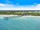 Stunning aerial view of the pier and the beach at 1307 Highland Greens Dr, Venice, FL 34285