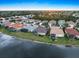 Panoramic aerial community view with picturesque waterfront homes by the lake under a bright blue sky at 1307 Highland Greens Dr, Venice, FL 34285
