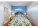 Cozy bedroom with a blue accent wall, queen bed, and access to an ensuite bathroom at 1307 Highland Greens Dr, Venice, FL 34285