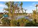 Community pool area surrounded by lush landscaping and inviting lounge chairs for relaxation at 1307 Highland Greens Dr, Venice, FL 34285