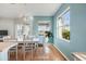 Dining room features a window with a view, wood flooring, and modern decor at 1307 Highland Greens Dr, Venice, FL 34285