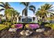 Welcoming entrance to 'The Club at Pelican Pointe' with vibrant landscaping and elegant signage at 1307 Highland Greens Dr, Venice, FL 34285