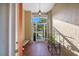 Inviting foyer featuring tile floors, a bench, a decorative hanging light fixture, and textured walls at 1307 Highland Greens Dr, Venice, FL 34285