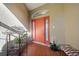 Welcoming front porch with colorful door, plants, and bench seating at 1307 Highland Greens Dr, Venice, FL 34285