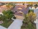 Stunning aerial view of a home showcasing a tile roof and a scenic lake in a vibrant community at 1307 Highland Greens Dr, Venice, FL 34285