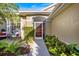 Charming front entrance with a lush garden, creating a welcoming curb appeal at 1307 Highland Greens Dr, Venice, FL 34285
