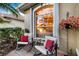 Welcoming front porch with seating area and view into the home's interior at 1307 Highland Greens Dr, Venice, FL 34285