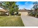 Charming single-story home featuring a well-manicured lawn and attached two-car garage at 1307 Highland Greens Dr, Venice, FL 34285