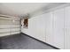 Well-organized garage featuring rubber flooring, ample storage cabinets, and overhead lighting at 1307 Highland Greens Dr, Venice, FL 34285