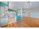 Open concept kitchen features tile flooring, white cabinets, and access to the living and dining spaces at 1307 Highland Greens Dr, Venice, FL 34285