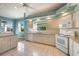 Bright kitchen features tiled flooring, white cabinets, modern appliances, and a window with a view at 1307 Highland Greens Dr, Venice, FL 34285