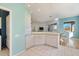 Spacious kitchen with white cabinets, light countertops, an island, and an open layout for easy entertaining at 1307 Highland Greens Dr, Venice, FL 34285