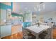 Bright and open kitchen and dining area features stylish white cabinets and plenty of natural light at 1307 Highland Greens Dr, Venice, FL 34285