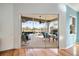 View of the lanai showing the sliding door access, outdoor furniture, and view of the backyard at 1307 Highland Greens Dr, Venice, FL 34285