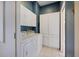Functional laundry room with large washer and dryer, white cabinets and ample storage at 1307 Highland Greens Dr, Venice, FL 34285