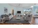 Bright living room with hardwood floors, neutral furniture, and an outdoor view at 1307 Highland Greens Dr, Venice, FL 34285