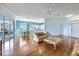 Bright living room showcasing laminate floors, ample natural light, and open access to the kitchen and dining area at 1307 Highland Greens Dr, Venice, FL 34285
