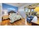 Relaxing main bedroom features a ceiling fan, wood floor, and sliding glass doors to the outdoor space at 1307 Highland Greens Dr, Venice, FL 34285