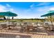 Outdoor dining area with comfortable seating, providing a relaxing space to enjoy the beautiful golf course views at 1307 Highland Greens Dr, Venice, FL 34285