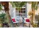 Cozy outdoor patio with seating, perfect for relaxing under the shade of palm trees at 1307 Highland Greens Dr, Venice, FL 34285