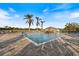 Community pool with a cabana and lush landscaping at 1307 Highland Greens Dr, Venice, FL 34285