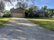 Front exterior view of a single-Gathering home with a two-car garage, driveway, and front lawn at 1315 Cambron Dr, Valrico, FL 33596