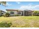 Well-manicured backyard featuring a screened-in patio, lush lawn, and beautiful landscaping at 13510 Esposito St, Venice, FL 34293