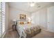 Comfortable bedroom with floral bedding, side tables with lamps, and a ceiling fan at 13510 Esposito St, Venice, FL 34293