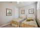 Charming twin bedroom featuring tropical artwork and plush bedding for a cozy feel at 13510 Esposito St, Venice, FL 34293