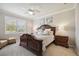 Elegant bedroom featuring a carved wood bed frame, soft lighting, and neutral decor at 13510 Esposito St, Venice, FL 34293