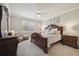Cozy bedroom features a carved wood bed frame, a window with blinds, and neutral decor at 13510 Esposito St, Venice, FL 34293