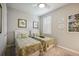 Inviting bedroom with twin beds, tropical-themed decor, and natural light at 13510 Esposito St, Venice, FL 34293