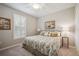 Comfortable bedroom with floral bedding, plantation shutters, and a ceiling fan at 13510 Esposito St, Venice, FL 34293