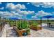 Community garden featuring raised planting beds, pavers, and shaded seating areas at 13510 Esposito St, Venice, FL 34293