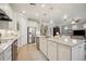 Spacious, bright kitchen features stainless steel appliances and a large island with pendant lighting at 13510 Esposito St, Venice, FL 34293