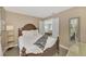 Cozy bedroom with a wooden frame bed and neutral color scheme at 13540 Dibella Ave, Port Charlotte, FL 33981