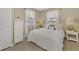 Comfortable bedroom with white bedding and wicker furniture at 13540 Dibella Ave, Port Charlotte, FL 33981