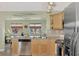 Kitchen features stainless steel appliances and light wood cabinets at 13540 Dibella Ave, Port Charlotte, FL 33981