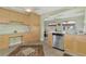 Bright kitchen with stainless steel appliances and light wood cabinets at 13540 Dibella Ave, Port Charlotte, FL 33981