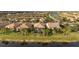 Aerial view of lakefront homes showcasing backyard patios at 13807 Karina St, Venice, FL 34293